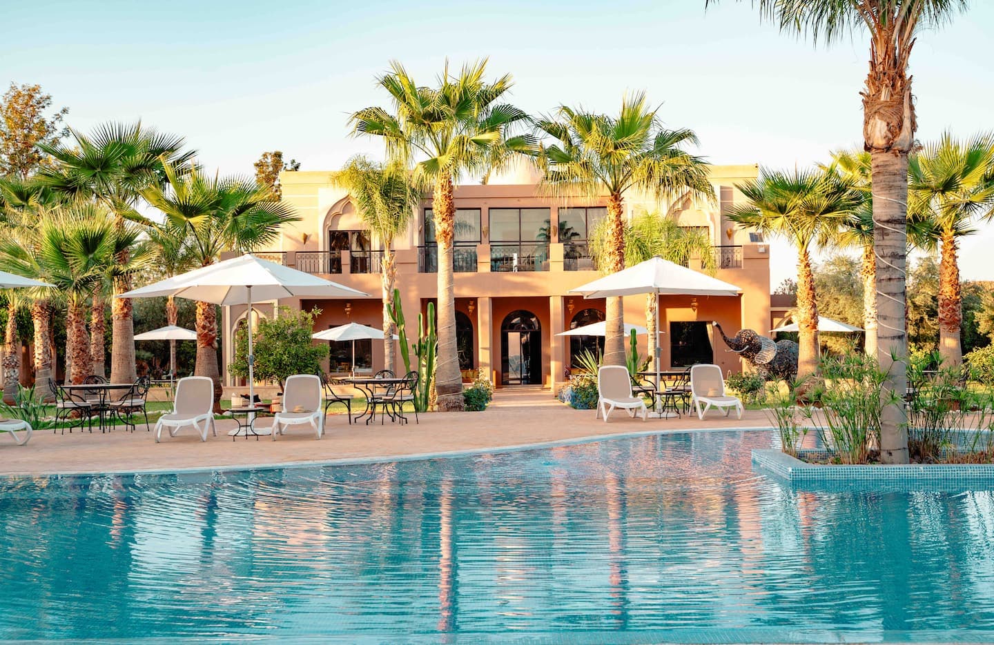 Palais Medali pool and villa at golden hour